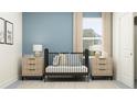 Cozy Bedroom featuring a black crib, neutral decor, a large window, and soft lighting at 11733 E 71St Ter, Palmetto, FL 34221