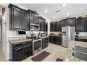 Elegant kitchen with stainless steel appliances, granite countertops, and dark wood cabinets at 11802 Twilight Darner Pl, Riverview, FL 33569