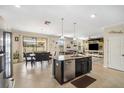 Open-concept kitchen with an island that flows into a dining area and living space at 11802 Twilight Darner Pl, Riverview, FL 33569