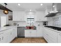 Bright kitchen with white cabinets, stainless steel appliances, and travertine floors at 13544 Avista Dr, Tampa, FL 33624