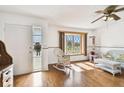 Bright living space featuring hardwood floors, a large lattice window, and comfortable wicker seating at 1436 Santa Clara Dr, Dunedin, FL 34698