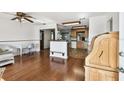 Open living area with gleaming hardwood floors, seamlessly flowing into adjacent kitchen at 1436 Santa Clara Dr, Dunedin, FL 34698