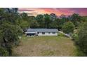 Backyard aerial view with screened in porch and mature trees lining the property for privacy at 16112 N 15Th St, Lutz, FL 33549