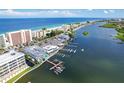 Breathtaking aerial view showcases waterfront property with dock, intercoastal access, and nearby beach at 20019 Gulf Blvd # 1, Indian Shores, FL 33785