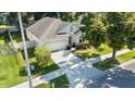 Aerial front view of the home, showcasing the driveway, landscaping, and well-maintained lawn at 203 Montara Dr, Seffner, FL 33584