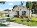 Charming single-story home with a manicured lawn, a two-car garage, and a welcoming entrance at 203 Montara Dr, Seffner, FL 33584