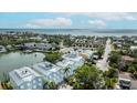 Aerial view of homes with light roofs, a calm bay, and a view of the ocean at 215 18Th Ave, Indian Rocks Beach, FL 33785