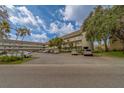 Exterior of complex featuring ample parking and well maintained landscaping at 2441 Persian Dr # 61, Clearwater, FL 33763