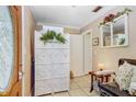 Light and bright foyer featuring tile floors, natural light, and a decorative folding screen at 2503 Victarra Cir, Lutz, FL 33559