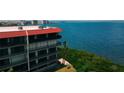Condominium building with multiple balconies overlooking bay views and lush greenery for outdoor enjoyment at 2700 Bayshore Blvd # 11405, Dunedin, FL 34698