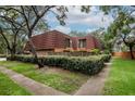 Charming townhome with a red tile roof, privacy fence, and mature landscaping at 2725 11Th Ct, Palm Harbor, FL 34684