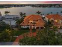 Stunning waterfront home with lush landscaping, tile roof, and circular driveway at 301 Bayview Ne Dr, St Petersburg, FL 33704