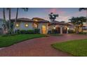 Beautiful Mediterranean-style home featuring a circular driveway, wrought iron gate, and two-car garage at 301 Bayview Ne Dr, St Petersburg, FL 33704