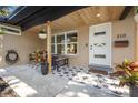 Charming front porch with patterned tiles, stylish seating, and freshly painted door at 310 55Th S Ave, St Petersburg, FL 33705
