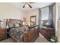 Cozy main bedroom with wooden furniture, decorative pillows, and natural light from the window at 3402 Stonebridge Trl, Valrico, FL 33596