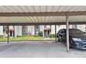Assigned carport parking with unit number and ample space for a vehicle, close to the residences at 3505 Tarpon Woods Blvd # P404, Palm Harbor, FL 34685
