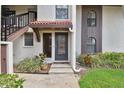 Charming entryway with tile roof, muted colors, and landscaped surroundings welcomes you home at 3505 Tarpon Woods Blvd # P404, Palm Harbor, FL 34685
