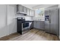 Updated kitchen features stainless steel appliances and gray cabinets at 3580 38Th S Ave # 95, St Petersburg, FL 33711