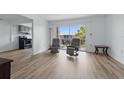 Open living space with new floors and sliding glass doors to the balcony at 3580 38Th S Ave # 95, St Petersburg, FL 33711
