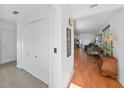 Welcoming foyer with closet and view into the spacious living room featuring hardwood floors and natural light at 37420 Teaberry Loop, Zephyrhills, FL 33542