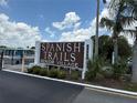 Spanish Trails Senior Village community sign with palm trees and blue sky in the background at 37832 Madeira Ave, Zephyrhills, FL 33541