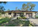 Inviting front exterior with attached garage and well-maintained landscaping at 4221 Burrows Rd, Zephyrhills, FL 33542
