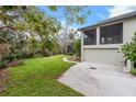 Home showcasing a large lawn, a paved driveway and a two-story screened in patio at 4641 John Moore Rd, Brandon, FL 33511