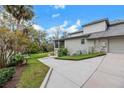 Exterior view of a home with a concrete driveway and lush landscaping at 4641 John Moore Rd, Brandon, FL 33511