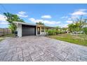 The front exterior shows a paved driveway leading to the garage and front entrance at 4726 W Fairview Hts, Tampa, FL 33616