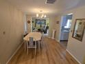 Cozy dining room with chandelier, hardwood floors, and natural light at 5031 Billings Dr, Holiday, FL 34690