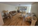 Bright living room featuring hardwood floors and large windows at 5031 Billings Dr, Holiday, FL 34690