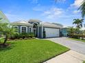 This attractive single-story home features a well manicured green lawn, paver driveway and a two car garage at 574 Bimini Bay Blvd, Apollo Beach, FL 33572