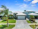 Beautiful single-story home with mature landscaping, a paver driveway, a two-car garage and a lovely exterior at 574 Bimini Bay Blvd, Apollo Beach, FL 33572