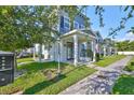 Charming townhouse boasts blue and white exterior with inviting front porch and well-kept lawn, creating a welcoming curb appeal at 6619 S Manhattan Ave # 1, Tampa, FL 33616