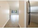Hallway leading to living room featuring modern flooring and stainless steel refrigerator at 6960 20Th N Ave # 203B, St Petersburg, FL 33710