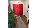 Bright entryway with hardwood floors, double doors, and a neutral-colored area rug at 7312 Nova Cir, Tampa, FL 33634