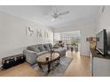 Bright living room with hardwood floors, a comfortable gray couch, and a view into the dining area at 800 S Dakota Ave # 337, Tampa, FL 33606