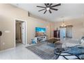 Spacious living room with tile flooring, a ceiling fan, and neutral paint to accommodate decor at 9314 Alta Sol Way, New Port Richey, FL 34655