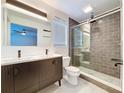 Modern bathroom featuring a double vanity, sleek shower with glass door, and contemporary finishes at 9580 130Th Ave, Largo, FL 33773