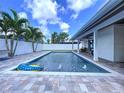 Inviting backyard with a sparkling pool, patio area, and lush landscaping for outdoor enjoyment at 9580 130Th Ave, Largo, FL 33773