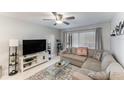 Bright living room featuring a cozy sectional sofa, ceiling fan, and plenty of natural light at 9700 Starkey Rd # 312, Seminole, FL 33777