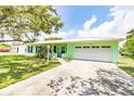 Charming single-story home features a bright exterior, manicured lawn, and an attached garage at 1022 Greenbriar Dr, Brandon, FL 33511