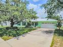 Charming single-story home features a bright exterior, manicured lawn, and an attached garage at 1022 Greenbriar Dr, Brandon, FL 33511
