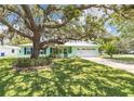 Charming single-story home features a bright exterior, manicured lawn, and an attached garage at 1022 Greenbriar Dr, Brandon, FL 33511
