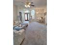 Spacious living room with plush seating, piano, and views of the front entrance at 10908 Sailbrooke Dr, Riverview, FL 33579
