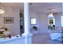Bright living room with white walls, carpet, and decorative columns at 10908 Sailbrooke Dr, Riverview, FL 33579