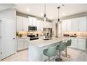 Bright kitchen featuring stainless appliances, white cabinetry, and a center island with seating at 1126 Creek Valley Ct, Brandon, FL 33511