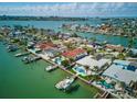 Stunning aerial view of waterfront homes, private docks and boats in clear, turquoise water on a sunny day at 11285 8Th E St, Treasure Island, FL 33706