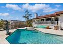 Backyard pool with clear water, diving board and mermaid statue, surrounded by a patio and landscaping at 11285 8Th E St, Treasure Island, FL 33706
