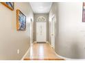 Bright foyer featuring tile flooring, neutral paint, and an arched transom window above the front door at 12746 Standbridge Dr, Riverview, FL 33579